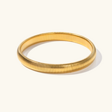 Daphne - Coil Bangle — bringing modern charm to your space. Daphne - Coil Bangle — bringing modern charm to your space.