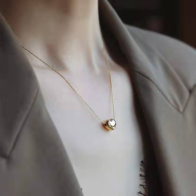 Irene - Gold Heart Necklace — bringing modern charm to your space. Irene - Gold Heart Necklace — bringing modern charm to your space.