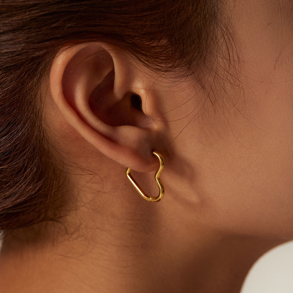 Clarissa - Heart Hoop Earrings — bringing modern charm to your space. Clarissa - Heart Hoop Earrings — bringing modern charm to your space.