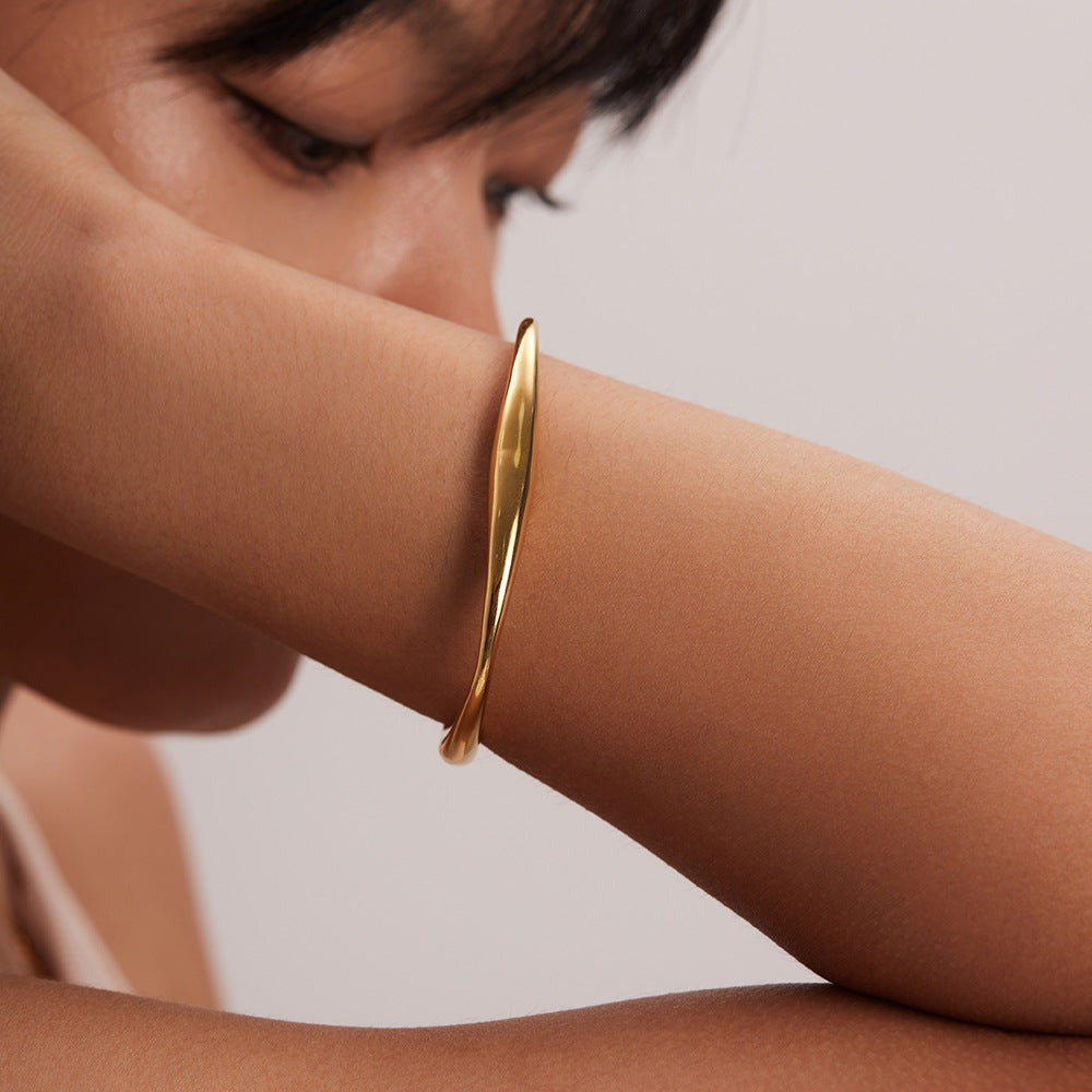Kennedy - Curved Gold Bangle — perfect for those who value comfort and design. Kennedy - Curved Gold Bangle — perfect for those who value comfort and design.