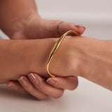 Kennedy - Curved Gold Bangle — perfect for those who value comfort and design. Kennedy - Curved Gold Bangle — perfect for those who value comfort and design.