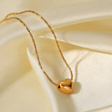 Irene - Gold Heart Necklace — bringing modern charm to your space. Irene - Gold Heart Necklace — bringing modern charm to your space.