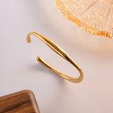 Kennedy - Curved Gold Bangle — perfect for those who value comfort and design. Kennedy - Curved Gold Bangle — perfect for those who value comfort and design.
