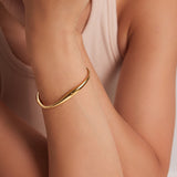 Kennedy - Curved Gold Bangle — perfect for those who value comfort and design. Kennedy - Curved Gold Bangle — perfect for those who value comfort and design.