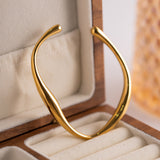 Kennedy - Curved Gold Bangle — perfect for those who value comfort and design. Kennedy - Curved Gold Bangle — perfect for those who value comfort and design.