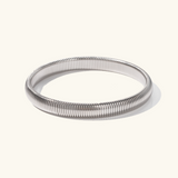 Daphne - Coil Bangle — bringing modern charm to your space. Daphne - Coil Bangle — bringing modern charm to your space.