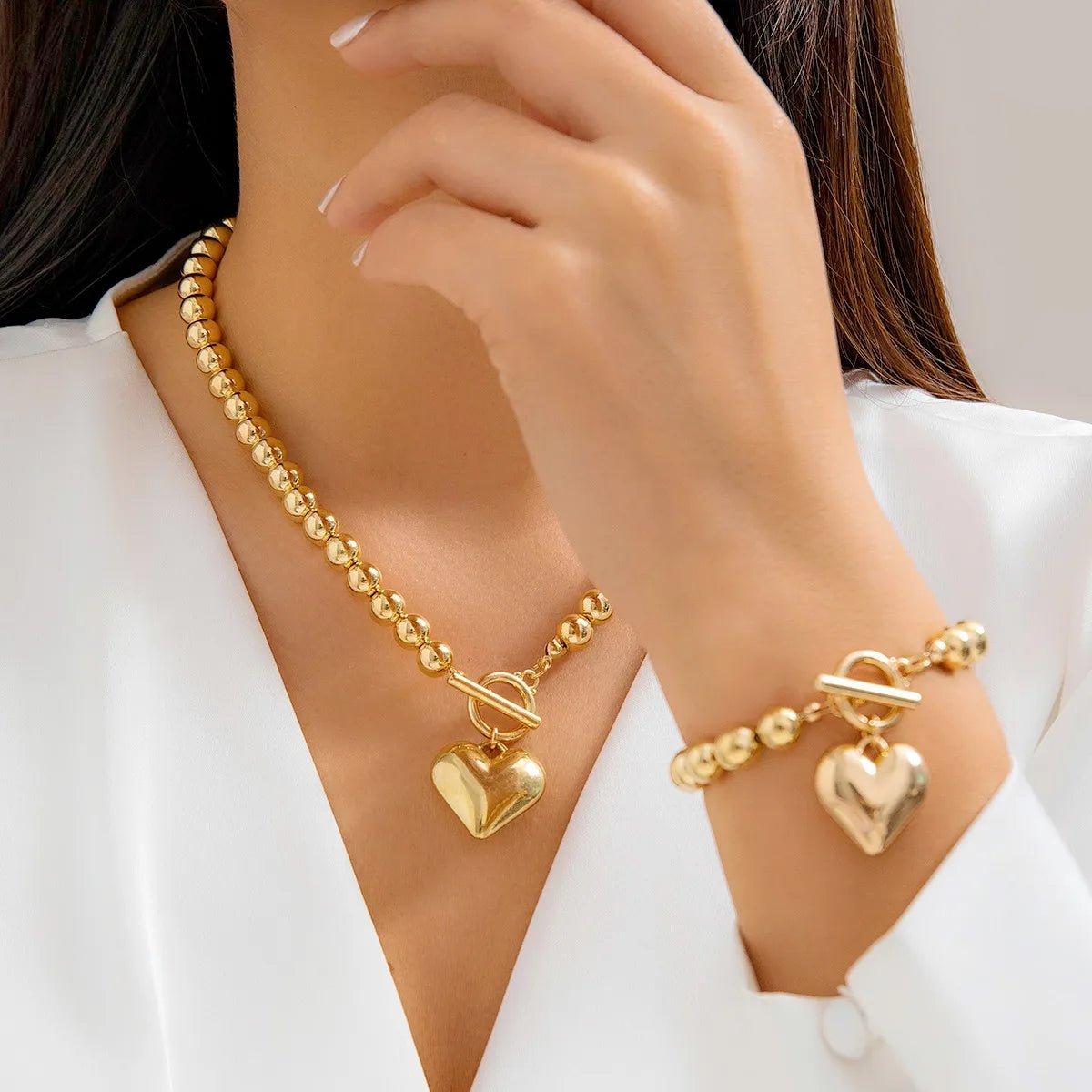 Calira - Beaded Heart Pendant Bracelet and Necklace Set Gold — perfect for those who value comfort and design. Calira - Beaded Heart Pendant Bracelet and Necklace Set Gold — perfect for those who value comfort and design.