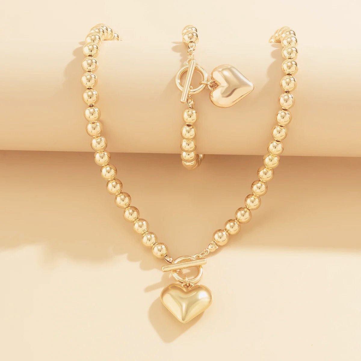 Calira - Beaded Heart Pendant Bracelet and Necklace Set Gold — perfect for those who value comfort and design. Calira - Beaded Heart Pendant Bracelet and Necklace Set Gold — perfect for those who value comfort and design.
