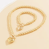 Calira - Beaded Heart Pendant Bracelet and Necklace Set Gold — perfect for those who value comfort and design. Calira - Beaded Heart Pendant Bracelet and Necklace Set Gold — perfect for those who value comfort and design.
