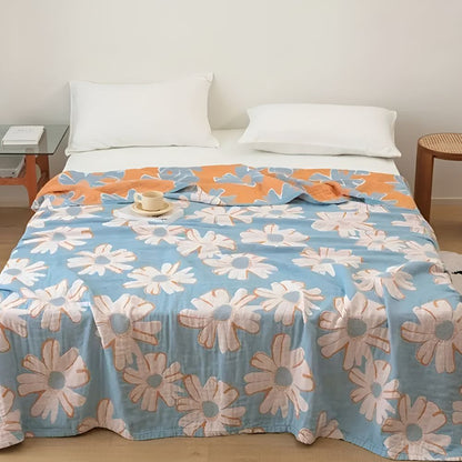 Couverture douce en coton à motif marguerites pour une décoration et un confort estivaux à la maison.