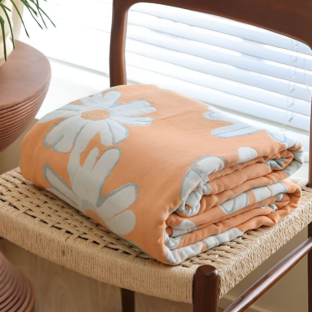 Couverture douce en coton à motif marguerites pour une décoration et un confort estivaux à la maison.