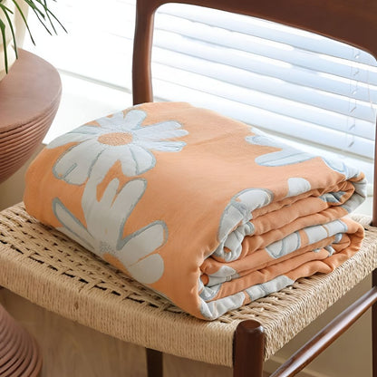 Couverture douce en coton à motif marguerites pour une décoration et un confort estivaux à la maison.