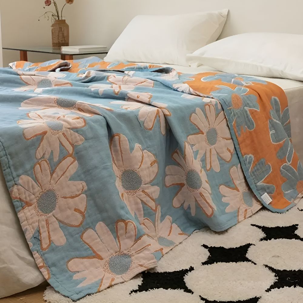 Couverture douce en coton à motif marguerites pour une décoration et un confort estivaux à la maison.