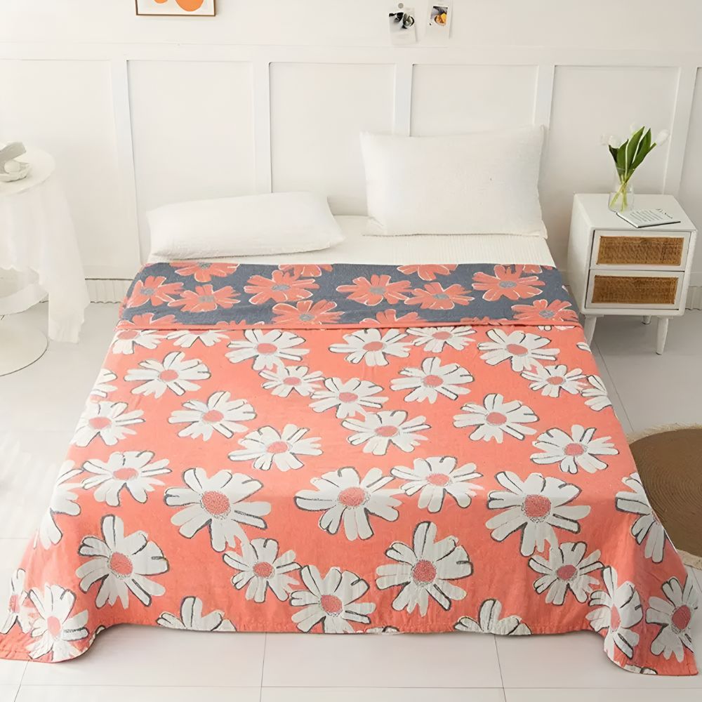 Couverture douce en coton à motif marguerites pour une décoration et un confort estivaux à la maison.