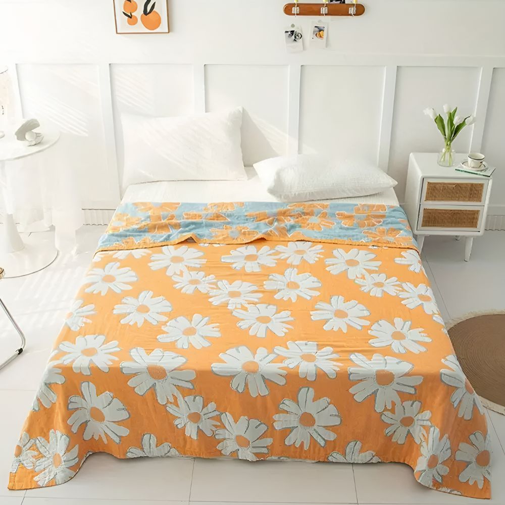 Couverture douce en coton à motif marguerites pour une décoration et un confort estivaux à la maison.